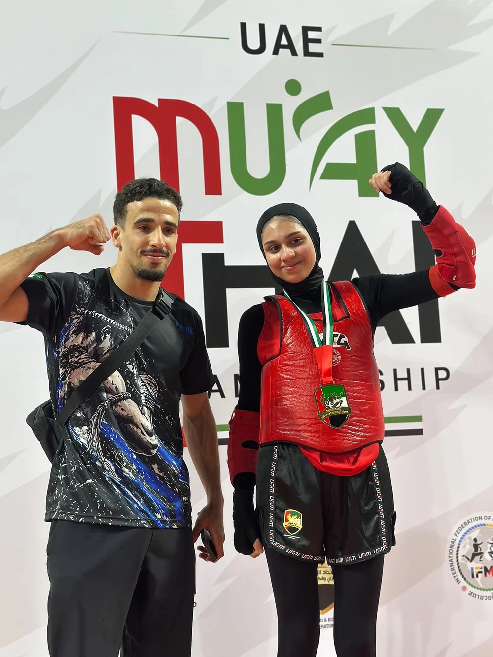 Mohamed Zohir with his student wearing a Muay Thai competition gold medal